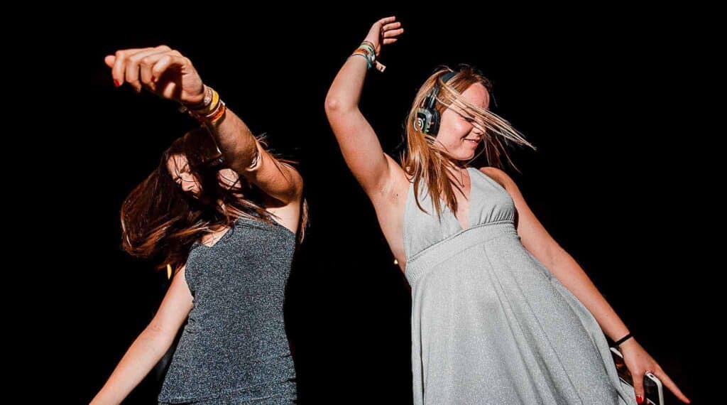 Girl dancing with silent disco headphones at a private party